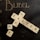 A set of Scrabble tiles arranged on a dark background to spell 'Happy Easter' with additional letters scattered around. The word 'BUBEL' is printed in gold on the upper part of the image.