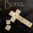 A set of Scrabble tiles arranged on a dark background to spell 'Happy Easter' with additional letters scattered around. The word 'BUBEL' is printed in gold on the upper part of the image.