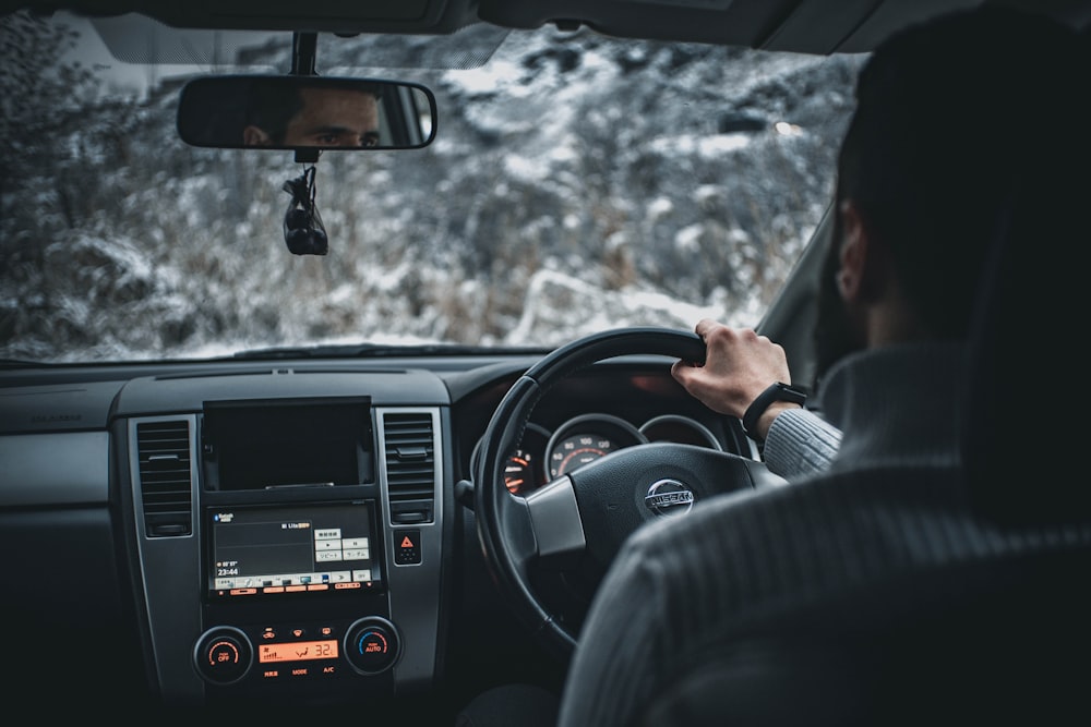 person driving car during daytime