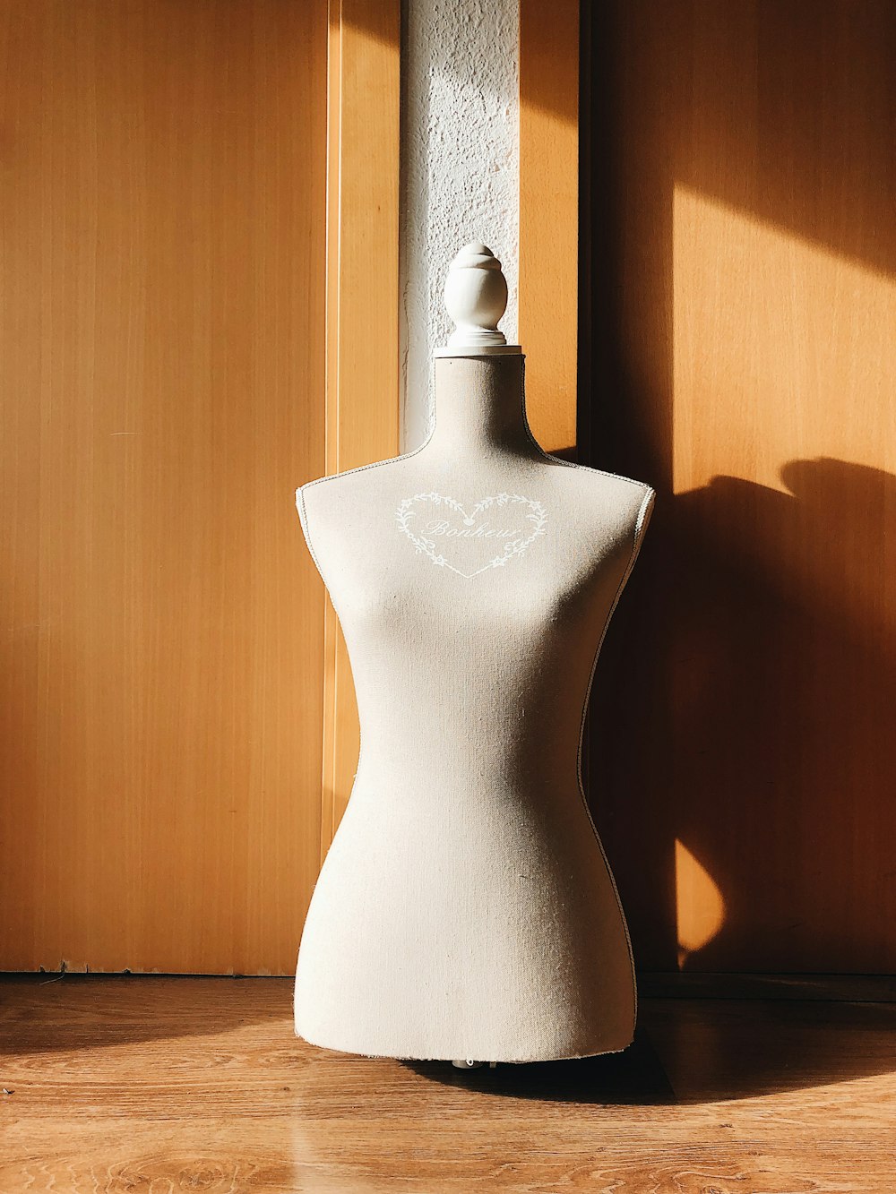 white ceramic vase on brown wooden table