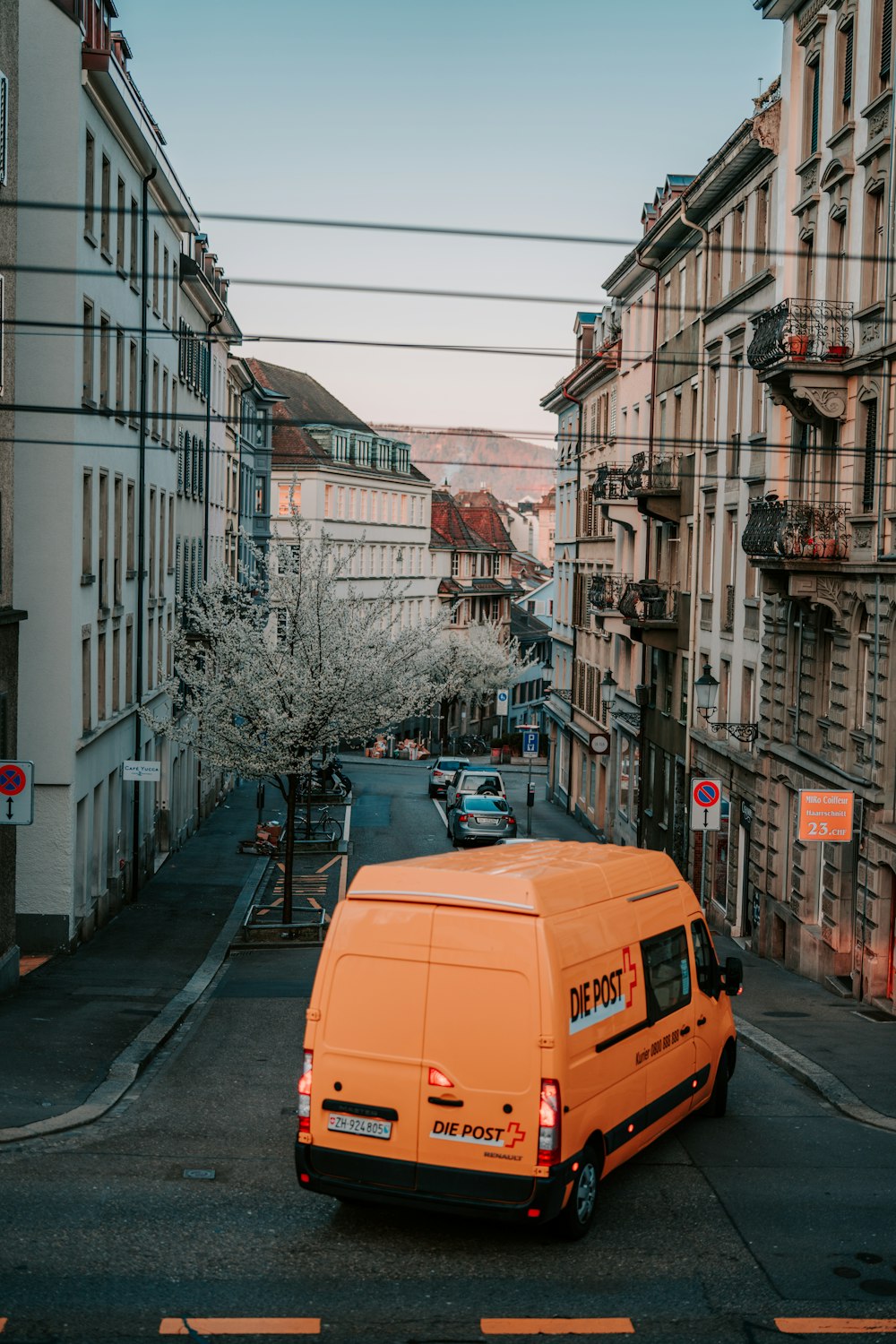 yellow bus on road near building during daytime