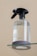 A clear spray bottle with a black trigger nozzle is placed on a glass surface. The bottle is transparent, partially filled with liquid, and has the word 'kinfill' printed on it.