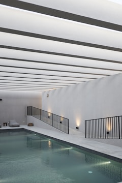 A modern pool design featuring elegant tiles and lighting.