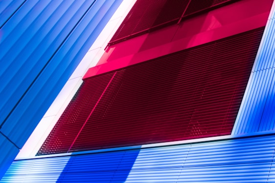 Professional contractor team painting a modern building with elegant red, white, gray, and black accents