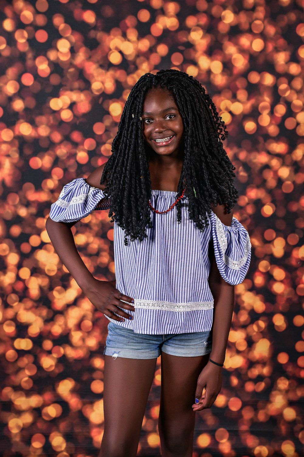 woman in white and black stripe shirt and blue denim shorts