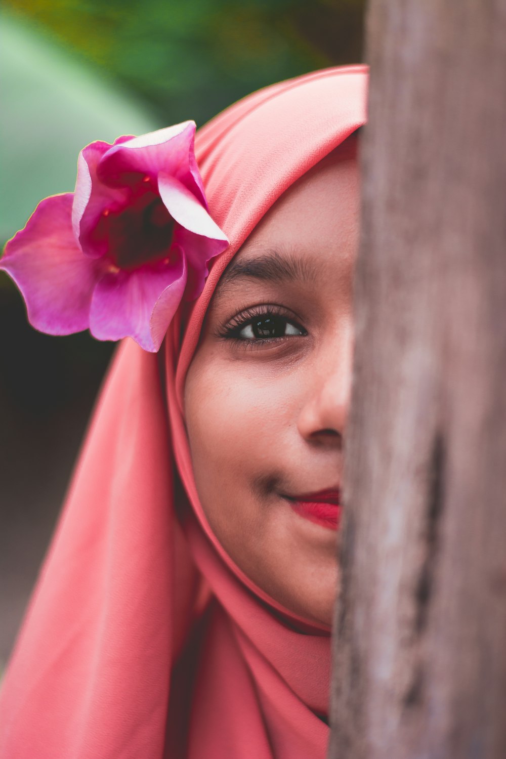 woman in pink hijab and red lipstick