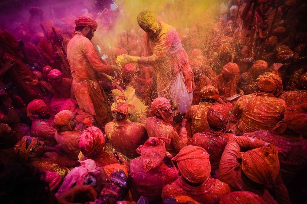 people in red and yellow dress dancing