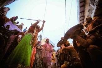 A colorful traditional festival in Obodoukwu with people dressed in Igbo attire dancing joyfully.