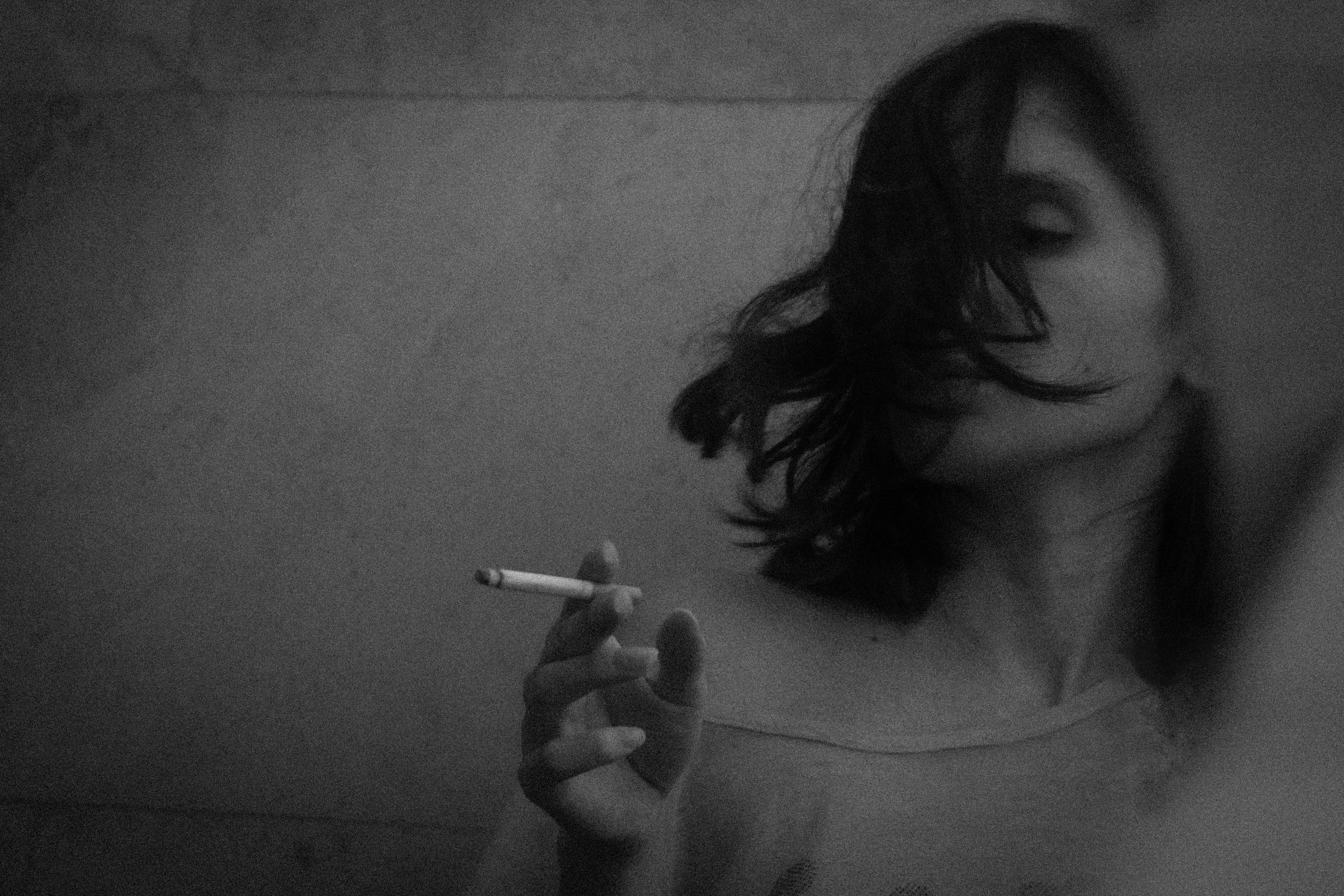 grayscale photo of woman smoking cigarette, 