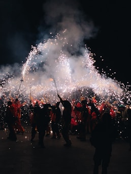 A joyful family gathered around a glowing firework display, smiling and celebrating together.