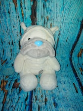 The blowbuddy in three colors—off-white, lavender purple, and dark slate grey—resting on a wooden table.