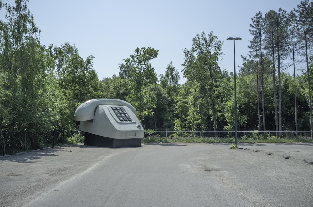 white and gray basketball hoop near green trees during daytime