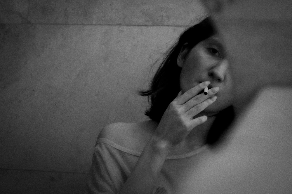 woman in tank top smoking cigarette
