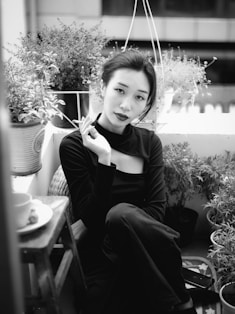 woman in black long sleeve shirt sitting on chair