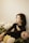 woman in black long sleeve shirt lying on white bed