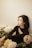 woman in black long sleeve shirt lying on white bed