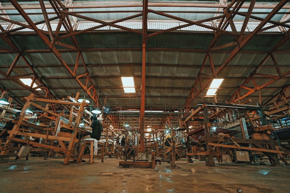 people sitting on brown wooden chairs inside building