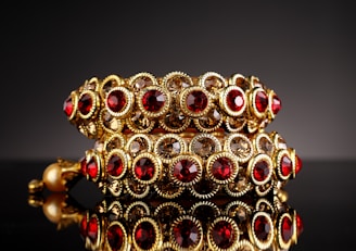 A stylish bracelet and cuff set resting on a wooden surface, highlighting their polished finish.