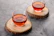 Set of elegant wooden coasters with custom laser-engraved designs, placed on a dark leather surface.