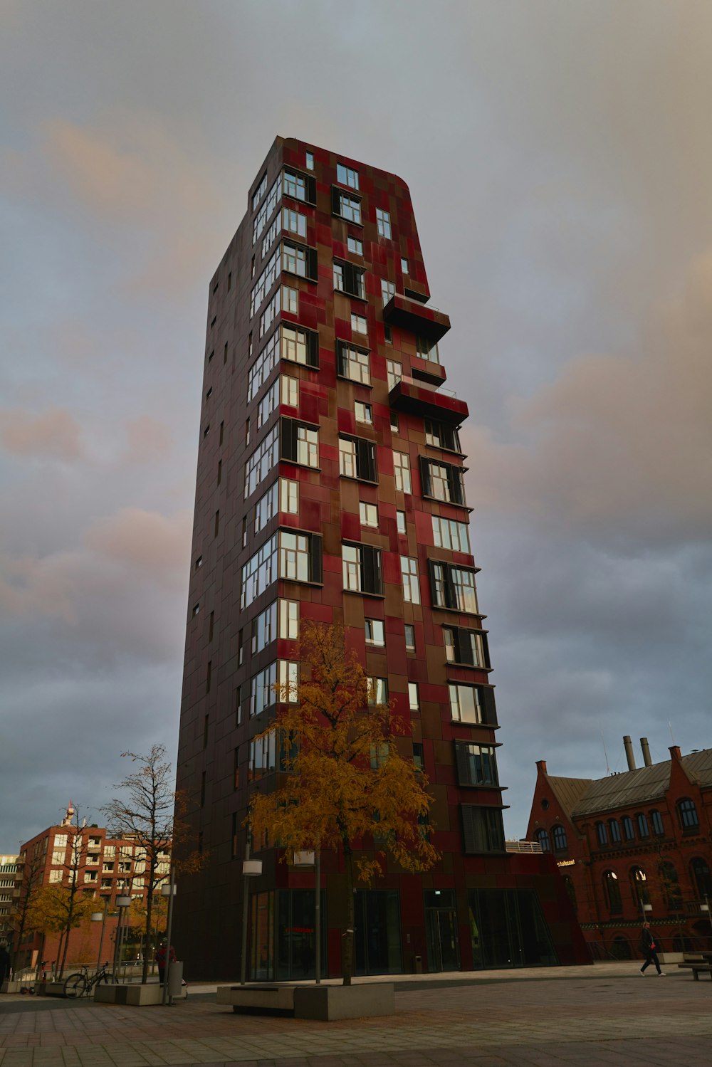 red concrete building near green trees during daytime