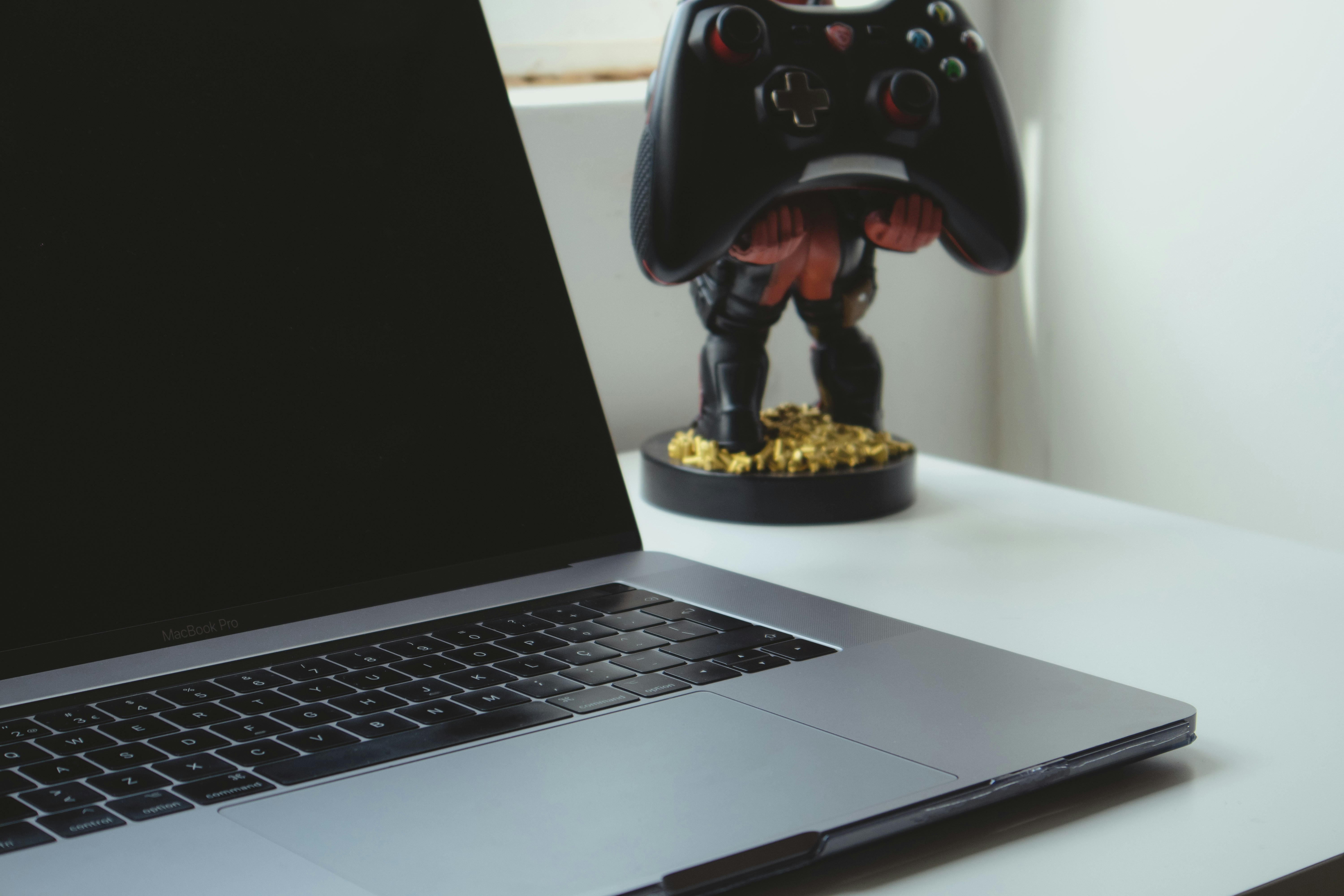 Happy Mac gamer playing a modern game on their MacBook Pro
