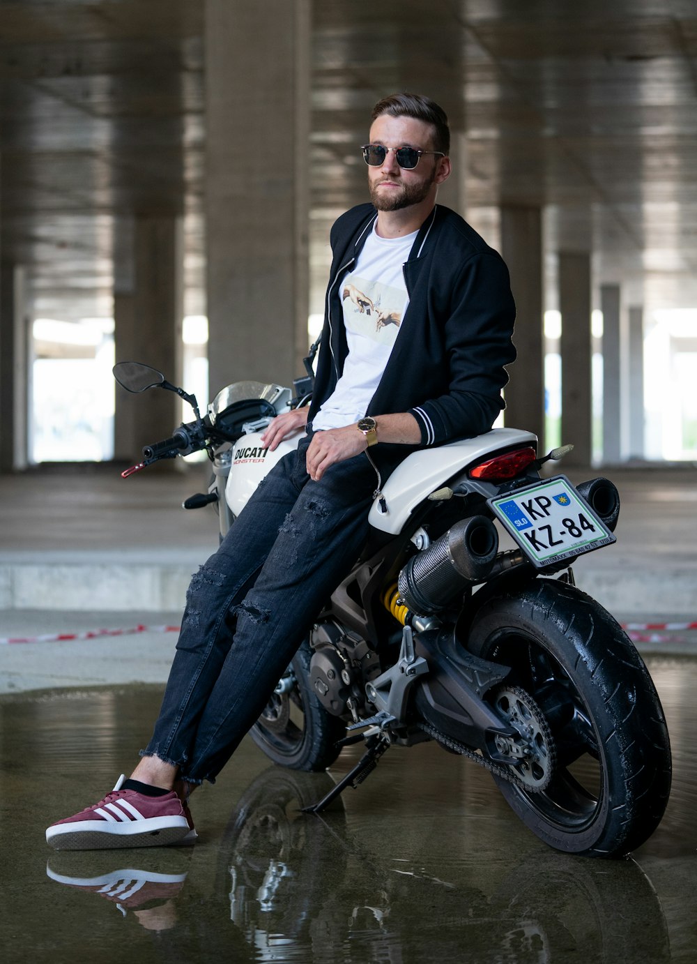 man in black suit riding on white and black motorcycle