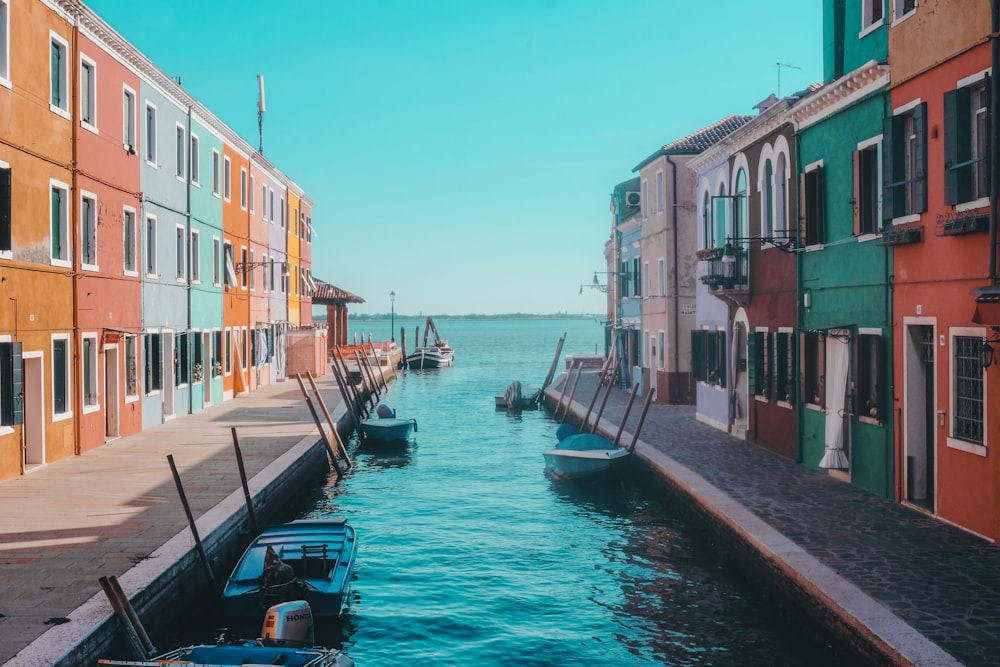 boat on dock near houses during daytime