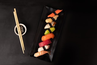 sushi on black square plate