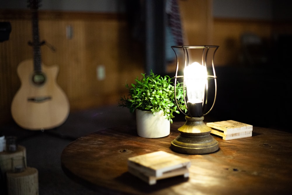 green plant in white ceramic vase on brown wooden table