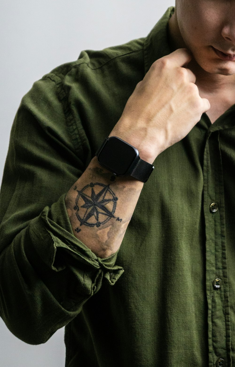 man in green button up shirt with black apple watch