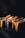 A collection of gourmet sandwiches is arranged artistically on a dark slate surface. The toasted sandwich slices display varied fillings, including a notable slice with vibrant orange roe, contrasting against the darker shades of the bread.