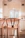 A stylish wicker bar stool in a modern kitchen setting.