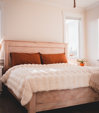 white bed linen on bed