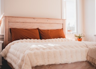 white bed linen on bed