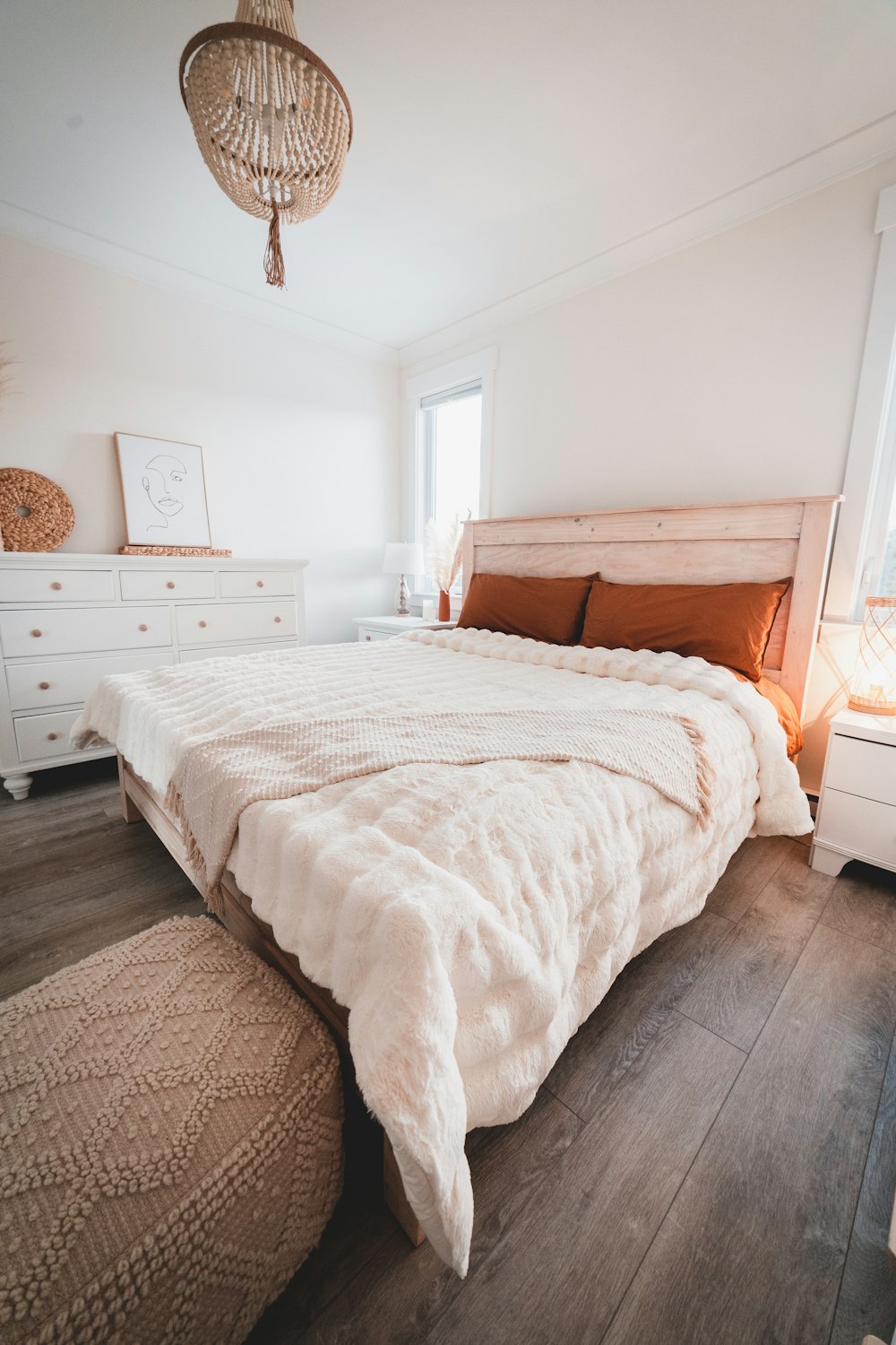 white bed linen on brown wooden bed frame
