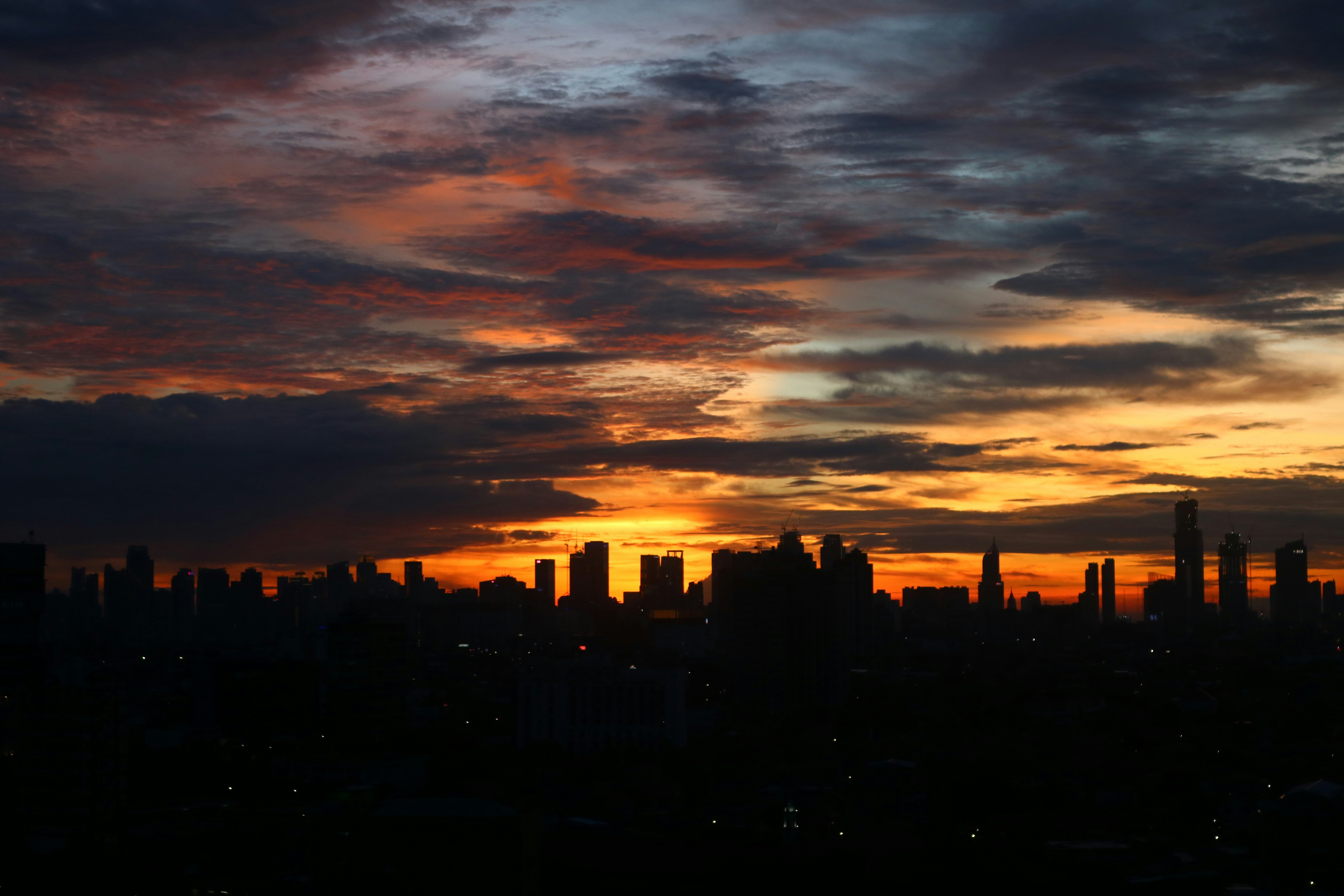 silhouette of city buildings during sunset