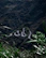 A scenic shot of a winding road through lush green mountains, inviting adventure.