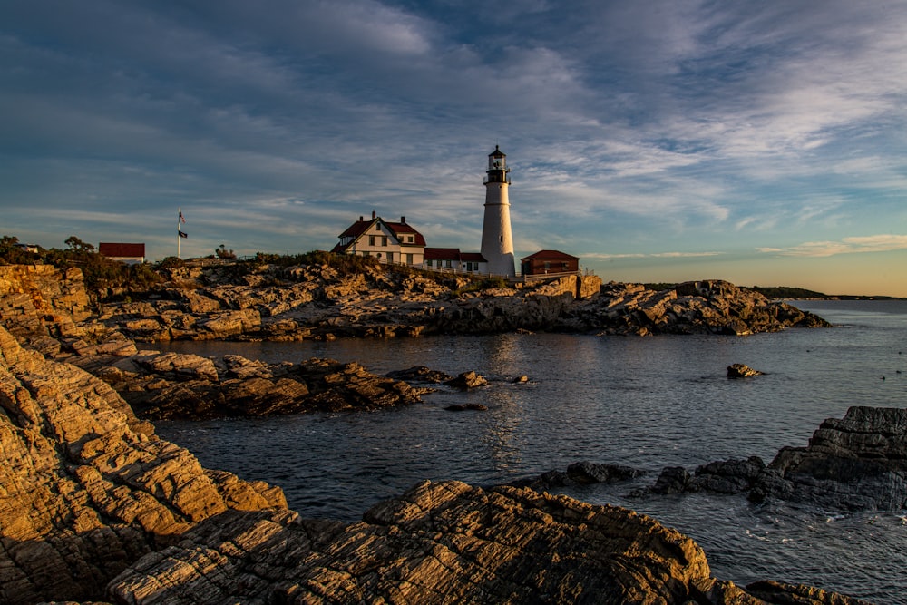 white and brown lighthouse near body of water during daytime