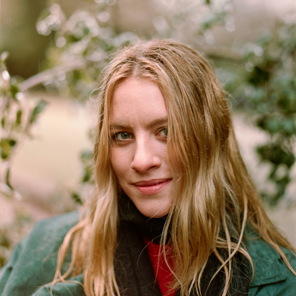 woman in green jacket smiling