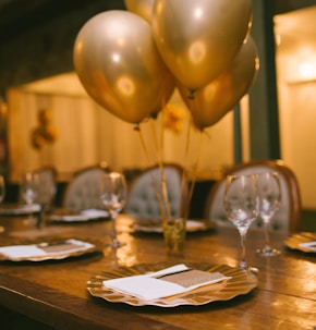 gold balloons on brown wooden table