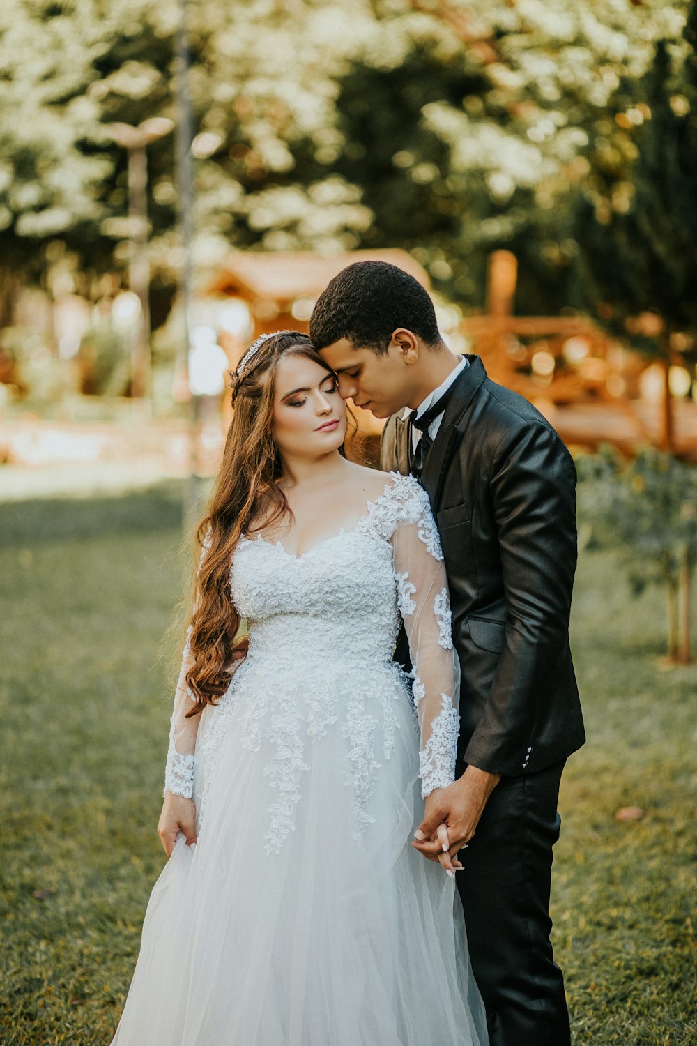 man in black suit jacket kissing woman in white wedding dress