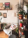 Room corner with decorative plants and a comfortable armchair.
