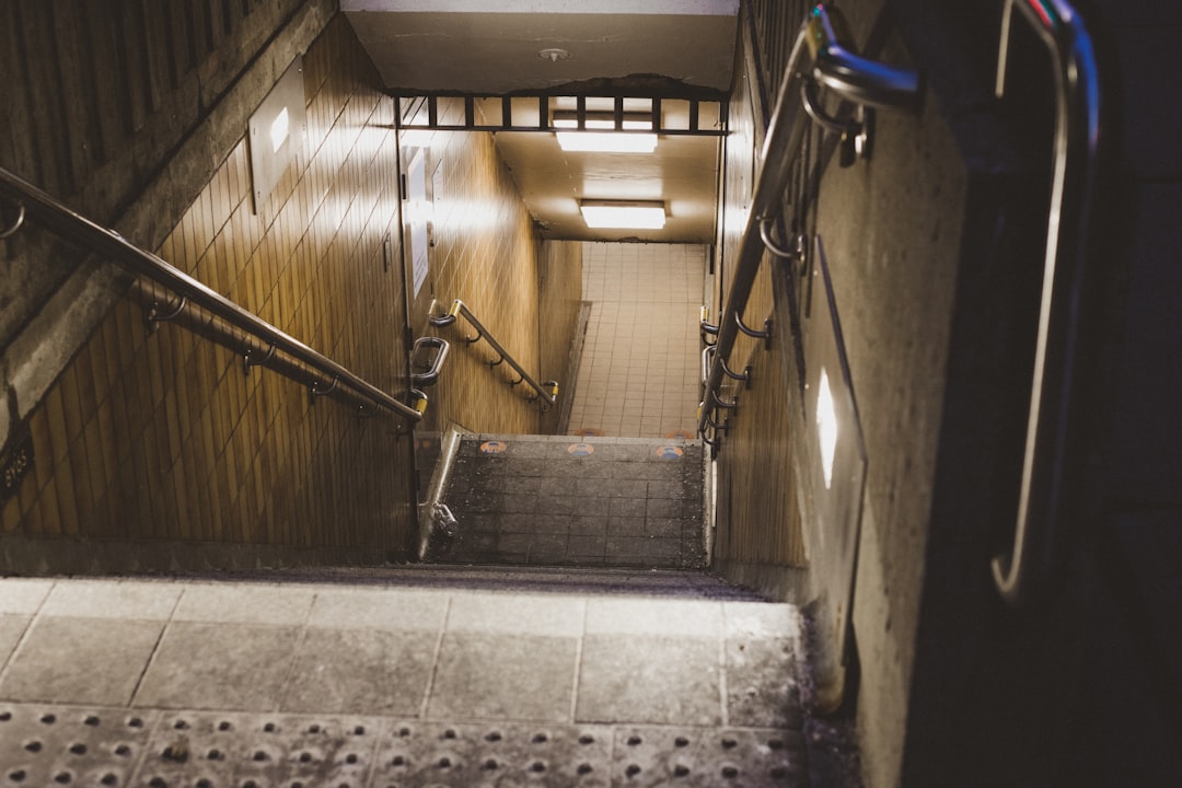 gray concrete staircase with stainless steel railings