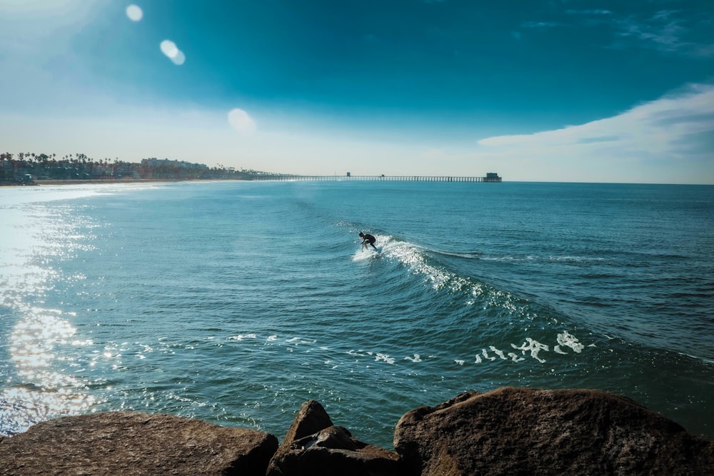 people surfing on sea during daytime