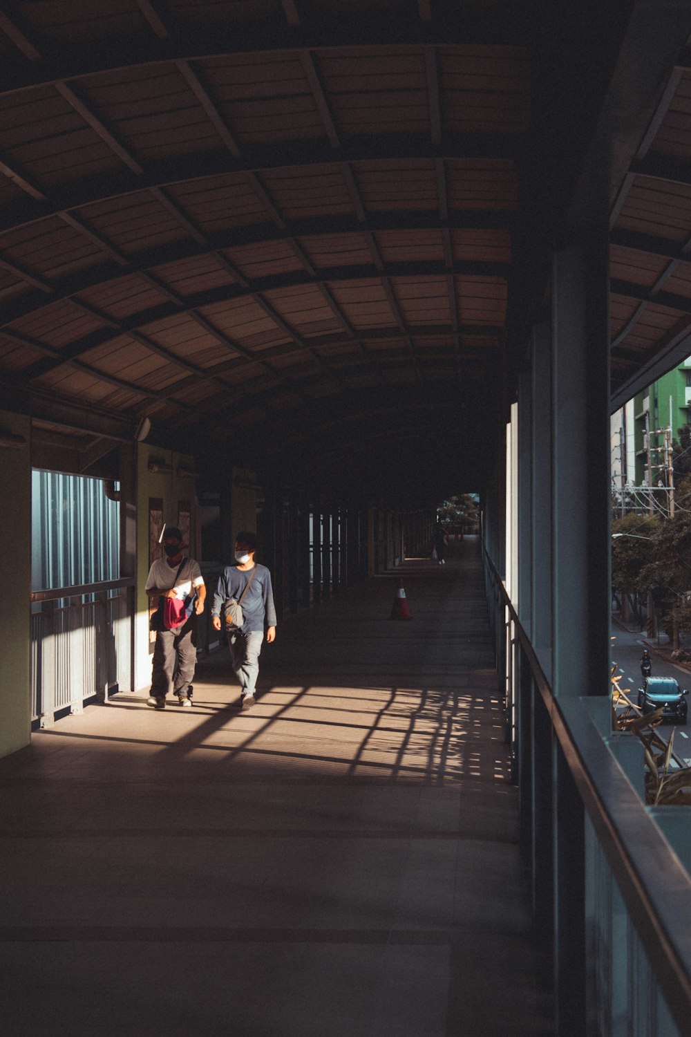 man in blue shirt walking on wooden floor