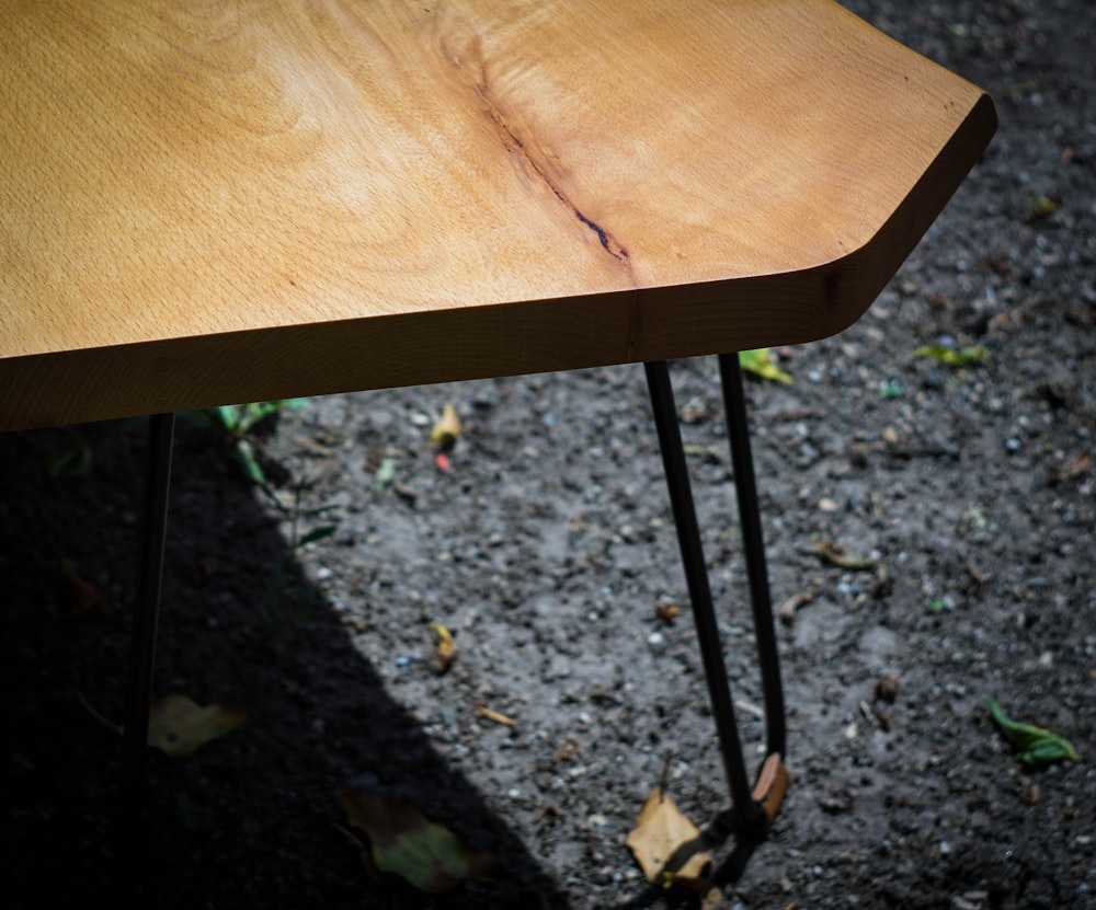 brown wooden table near green plants