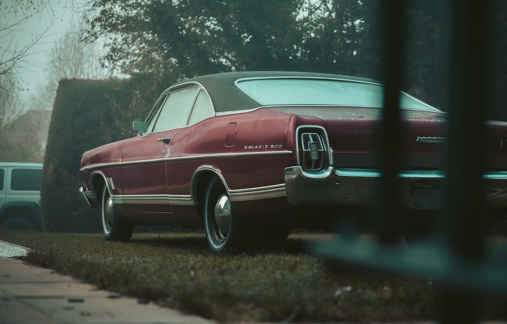 red and white vintage car on road during daytime