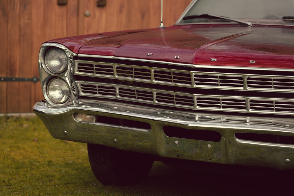 red car on green grass field during daytime