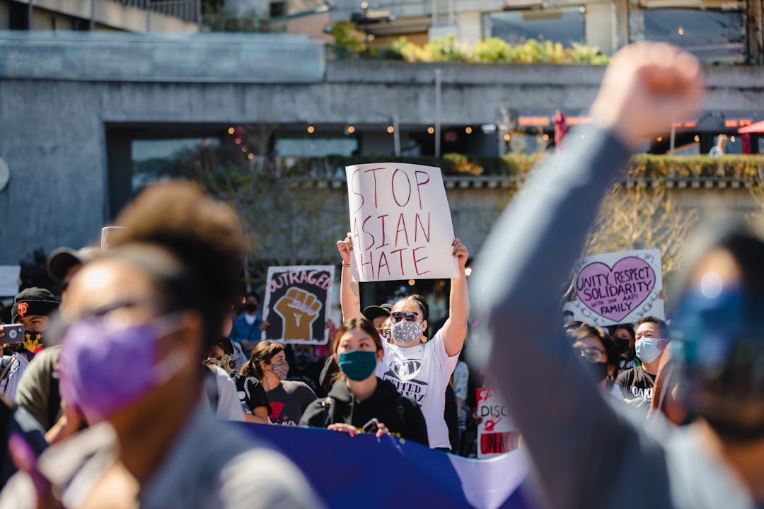 people holding white and blue banner during daytime