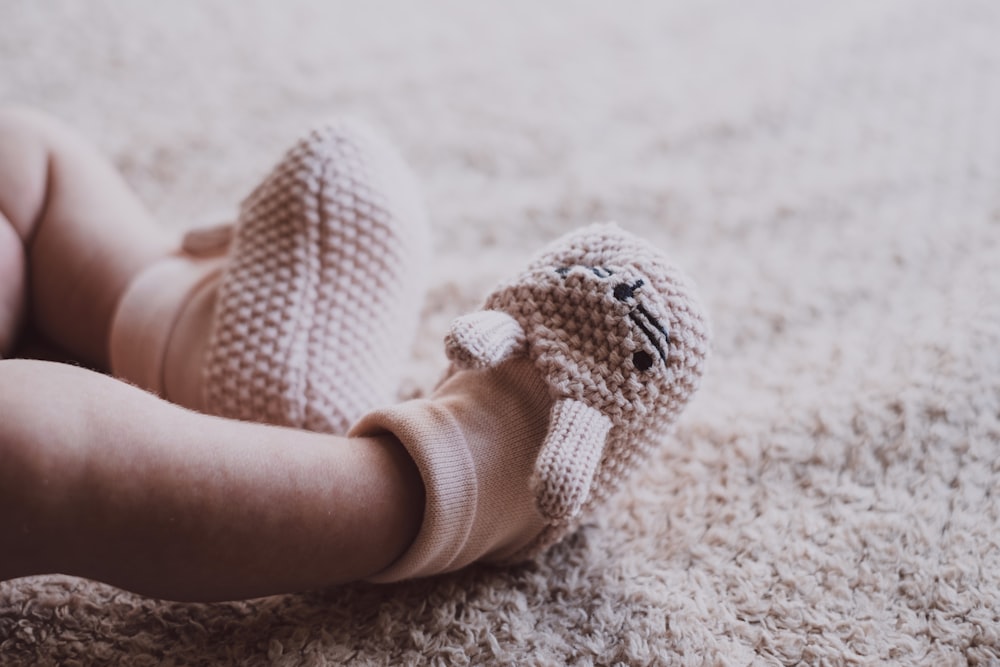 baby in white knit shoes